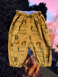 Image 1 of LITTLE PANTS - brown cartoon and red check flannelette 