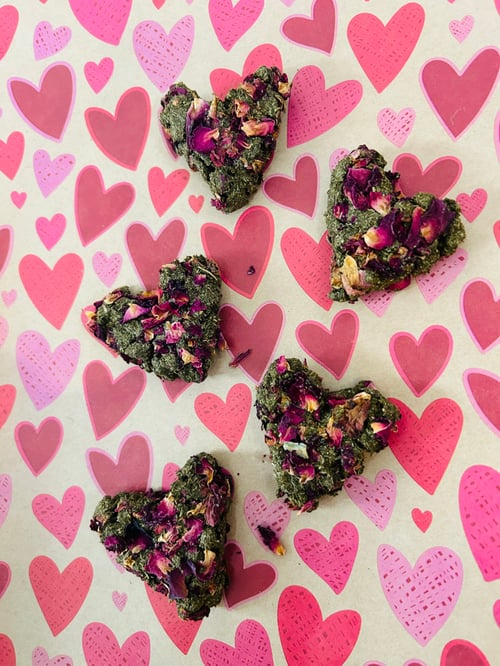 Image of Heart shaped healthy munchy treat bite with rose petals