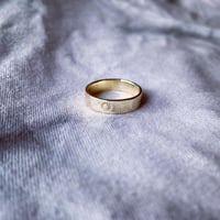 Image 1 of Celestial 9ct gold wedding ring with sun stamp detail. Cosmic sun gold wedding band stamped