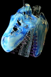 Image 1 of Glopal (uv reactive) T-Rex skull pendant with dichro tip and crushed opal teeth. 