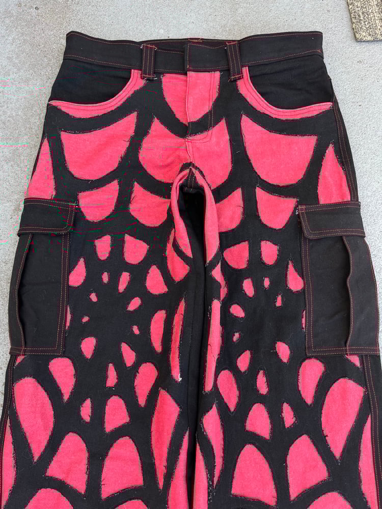 Image of red/blk web jeans