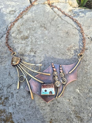 Necklace with a house under a mallow flower