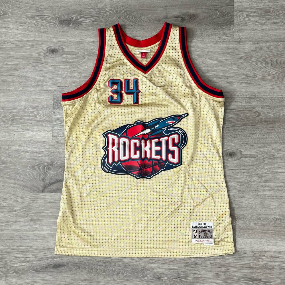 Image of Mitchell & Ness Hakeem Olajuwon 1996-97 Gold Swingman Jersey SIZE - LARGE