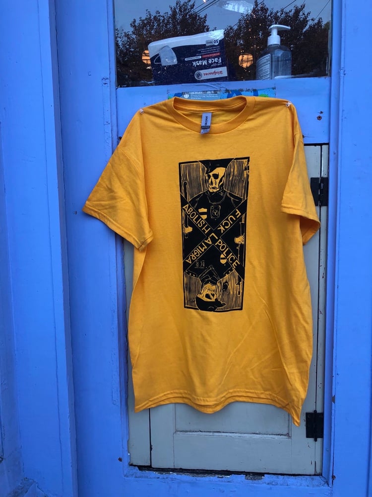 Image of gold shirt black ink