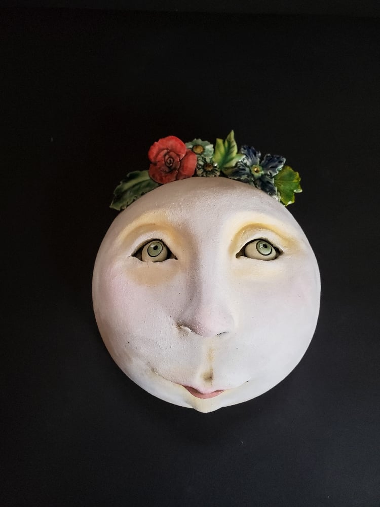 Wall mask with floral wreath