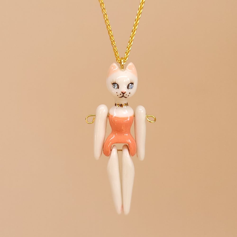 Image of White Porcelain & Gold Vermeil Articulated Doll Pendant