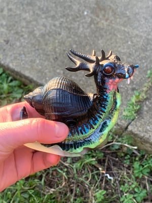 A Single Instance of SCP-111, “Dragon Snails”, The  Glowdrake®