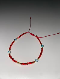 Image 1 of Teal evil eye red bracelet 