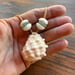 Image of Hawaiian Ivory Drupe Shell Necklace with Puka Shells, Teal Seaglass (22 inch)