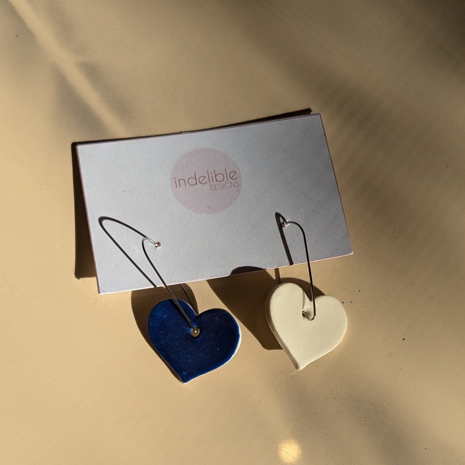 Image of blue and white heart asymmetrical earrings