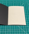Hand sewn softcover journal with black leaf cover
