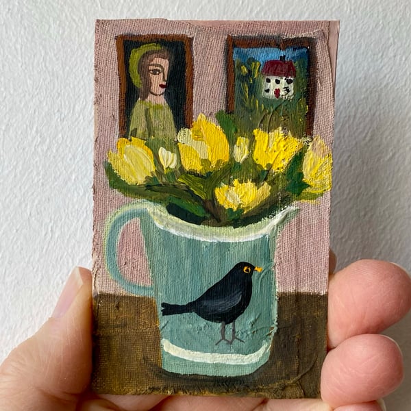 Image of a blackbird jug with yellow roses