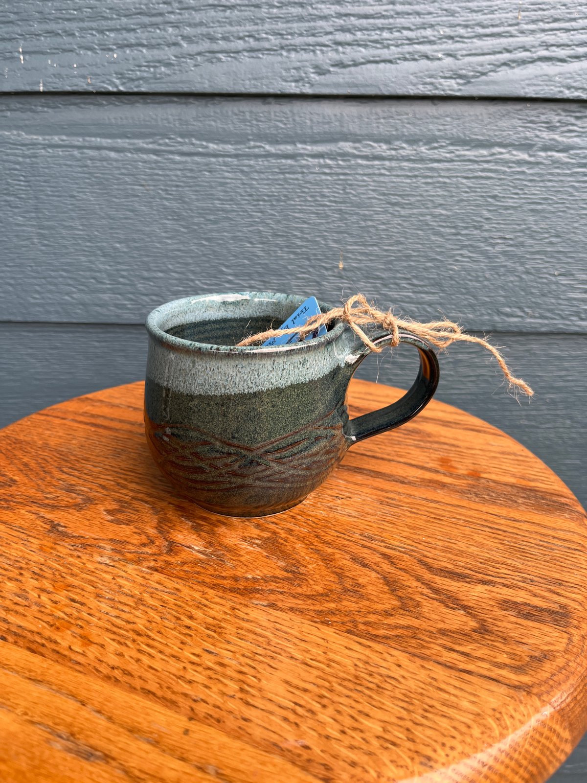 Image of M44 small mug with dark speckled glaze, round belly
