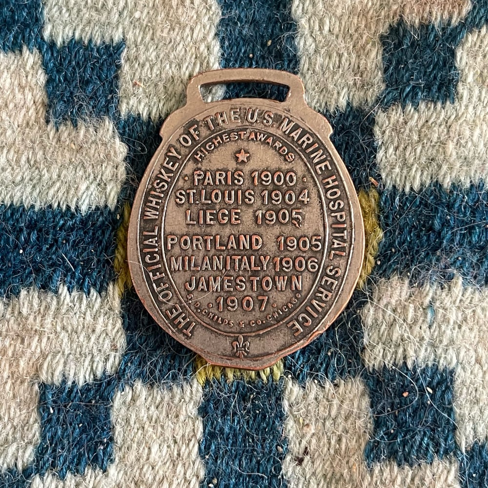 Antique Whiskey Fob “She Was Bred In Old Kentucky” 1910