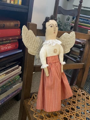 Image of A folk art angel in striped skirt