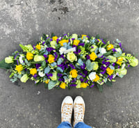 Rose carnation lis and statice coffin spray 