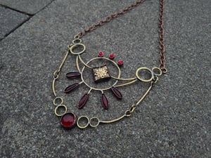 Red necklace with ethnic element 