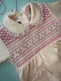 Image 1 of girls pink smocked babygrow