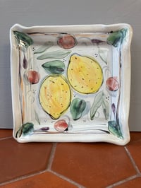 Image 1 of Square plate with lemons and cherries. 