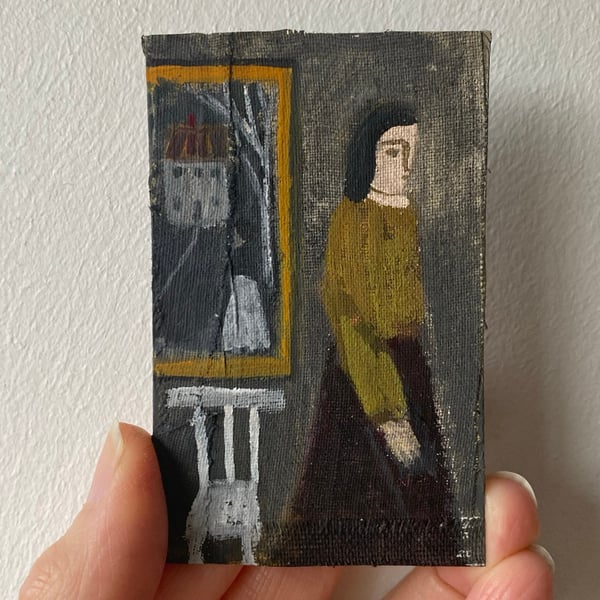 Image of Woman in a gallery with painting and chair