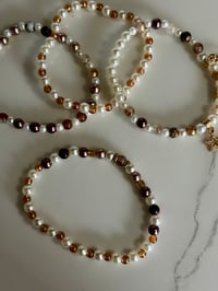 Image 8 of Starlight Shimmer Gold, Champagne, and Cream Tumbler Bracelet Stack