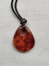 Baltic reddish Amber pendant with cord