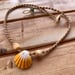 Image of Hawaiian sunrise shell necklace with golden pukas and a locking seaglass clasp