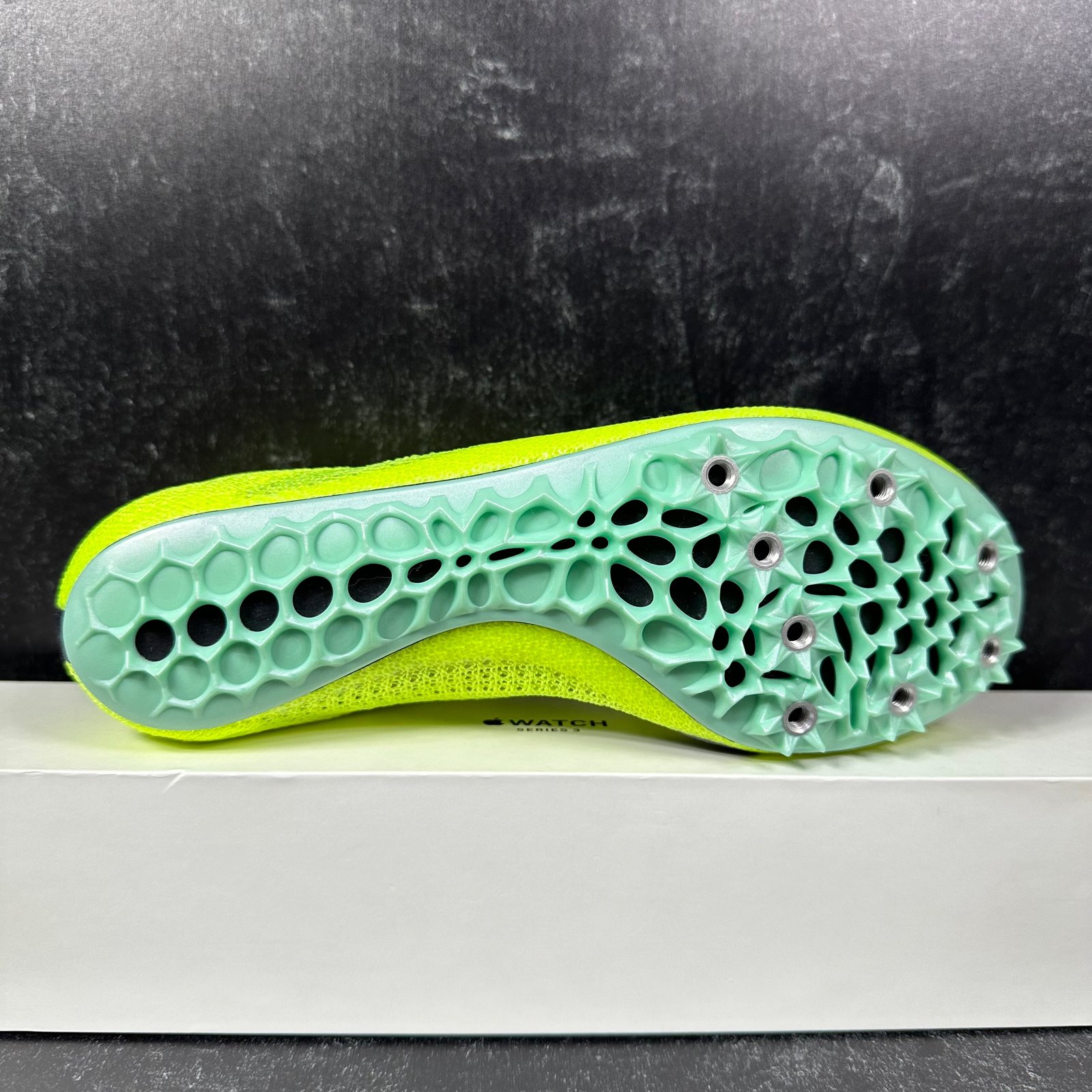 Green hot sale nike spikes