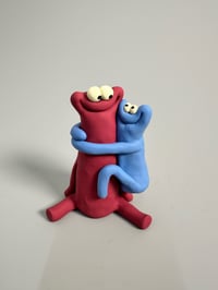 Image 1 of Blue thing hugging a red thing