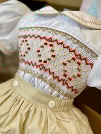 Image 1 of Cream and red smocked suit. 