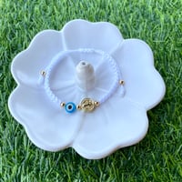 Image 1 of San Benito with blue evil eye bracelet