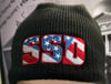 Black New Era SSD Democracy Knit Beanie with Rear “Vote Blue” logo