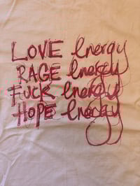 Image 1 of White T Shirt with ‘Energies’ in light purple text (5XL)