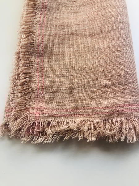 Image of ruby pale orange linen towel with pink stitching 