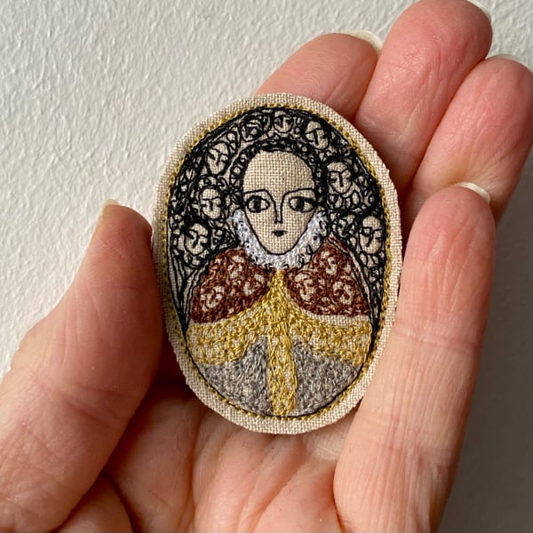 Image of Portrait of a regal figure with gold trimmed cape - smaller embroidery brooch 