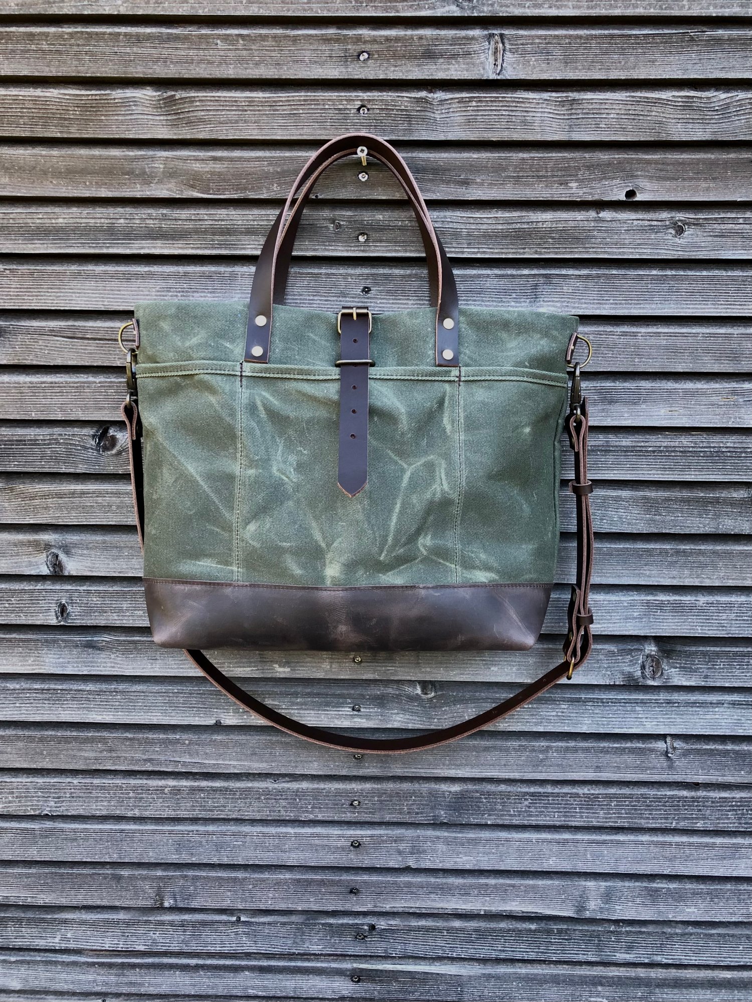 Image of Carryall  tote bag in olive green waxed filter twill with leather bottom and cross body strap