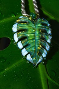 Image 1 of Drippy uv variegated monstera leaf pendant. 🌿💧