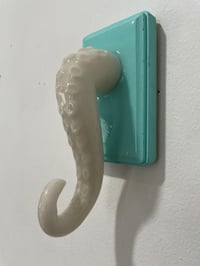 Image 3 of Single glow in the dark tentacle on teal jewelry holder