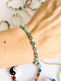 Image 1 of FUCK TRUMP MORSE CODE IN DAISIES BRACELET TEAL