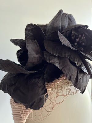 Image of Nude fabric covered shape w black silk flowers