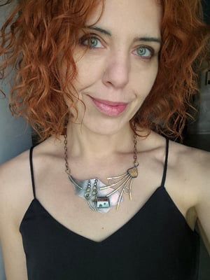 Necklace with a house under a mallow flower