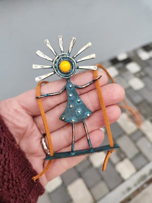 Sunny girl on the swing, blue patina