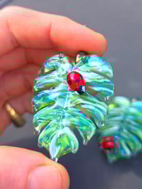 Image 1 of Drippy UV variegated monstera leaf with ladybug pendant.. 🐞🌿
