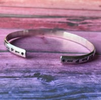Image 2 of 'Luna' symbol stamped cuff bracelet. Slim silver Aztec patterned cuff bracelet. 