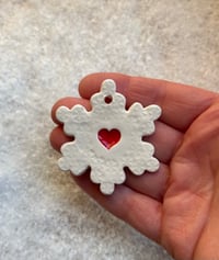 Image 1 of Snowflake with a heart on a wire stake 