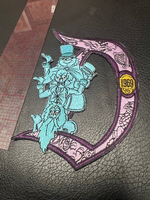Image of 9” Haunted Mansion Disneyland “D” 1969 patch with iron on backing