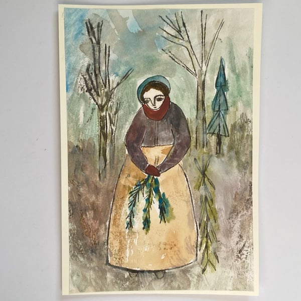 Image of Lady in a winter landscape with evergreen branches 