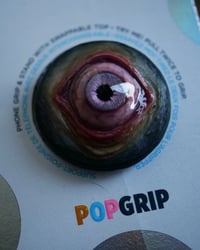 Image 4 of Custom Swappable Phone Grip for smartphones, reflective pupil, pink glow in the dark