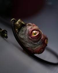 Image 3 of Egg of the King pendant, leather cord, brass hardware, all seeing glowing eyes