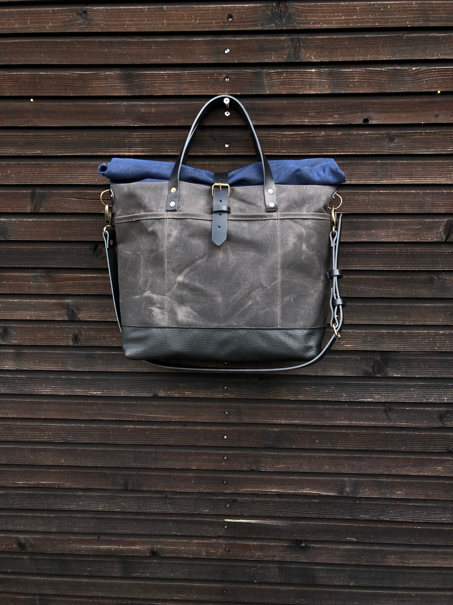 Image of Waxed canvas roll to close top tote bag with luggage handle attachment leather handles and shoul